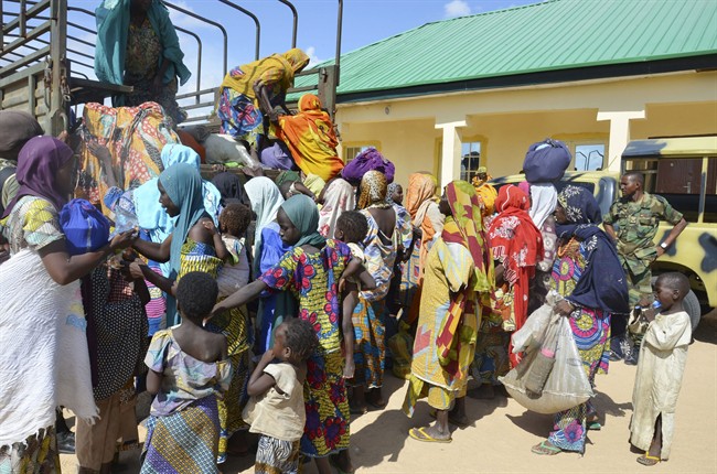 Women and children rescued by Nigerian soldiers from Boko Haram arrive in a military office in Maiduguri, Nigeria in this July 30, 2015 file photo.