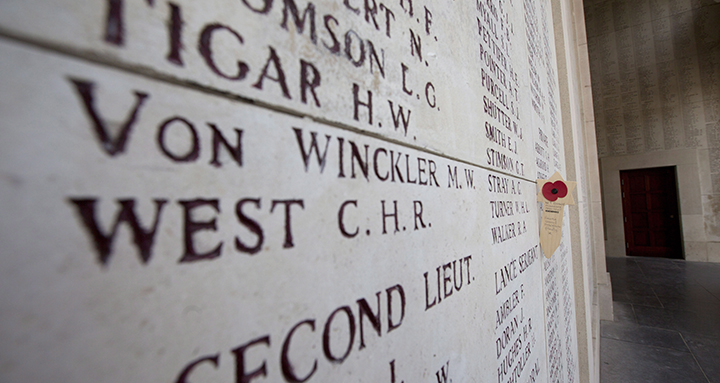 A wooden remembrance with a poppy is placed near names of the missing on the Menin Gate in Ypres, Belgium on Thursday, June 26, 2014. 