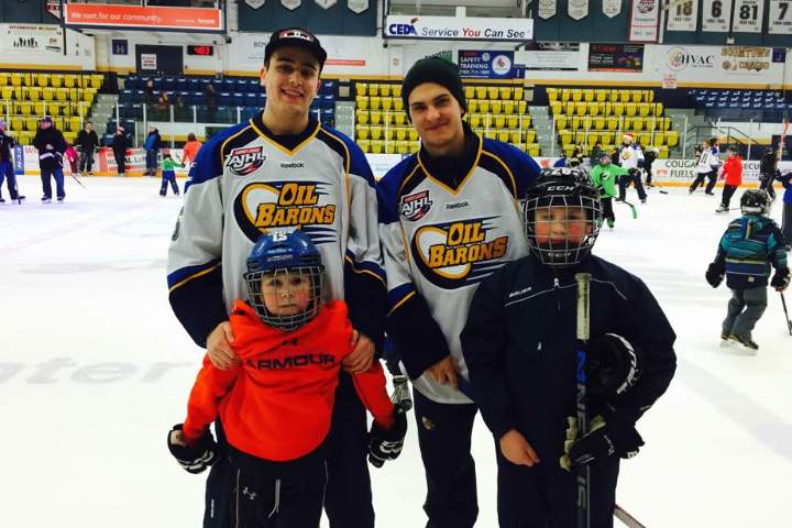 Oil Barons players pose with billet families.