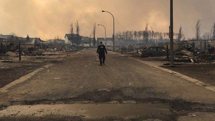 A member of the Alberta RCMP surveys the damage in Fort McMurray Thursday, May 5, 2016.
