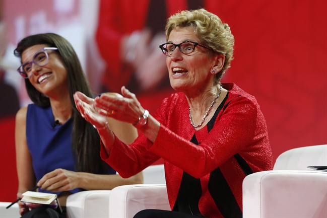 Ontario Premier Kathleen Wynne, right, speaks to Liz Plank onstage at the 2016 Liberal Biennial Convention in Winnipeg, Saturday, May 28, 2016.