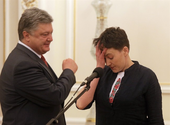 Ukrainian President Petro Poroshenko, left, looks at Ukrainian jailed pilot Nadezhda Savchenko during their meting in the Presidential Office in Kiev, Ukraine, Wednesday, May 25, 2016. Russia has released jailed pilot Nadezhda Savchenko, as part of a swap for two Russian servicemen imprisoned in Ukraine. (AP Photo/Efrem Lukatsky).