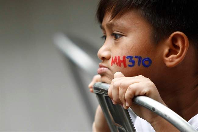 In this photo taken on Sunday, March 6, 2016, a Malaysian child with his face painted with MH370 during a remembrance event for the ill fated Malaysia Airlines Flight 370 in Kuala Lumpur, Malaysia.