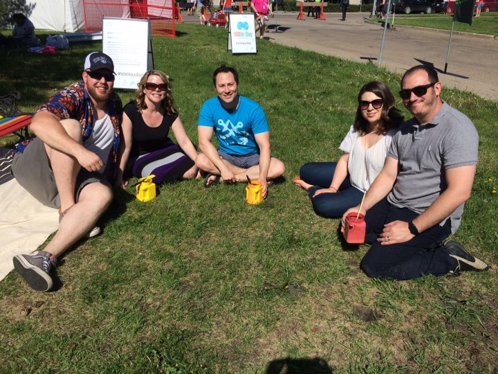 David Bayda and his friends pose for a picture after painting Pride Bench.