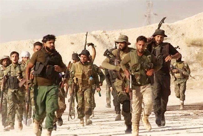 U.S.-backed Syrian rebels run in an unknown place in Syria, June 28, 2016.