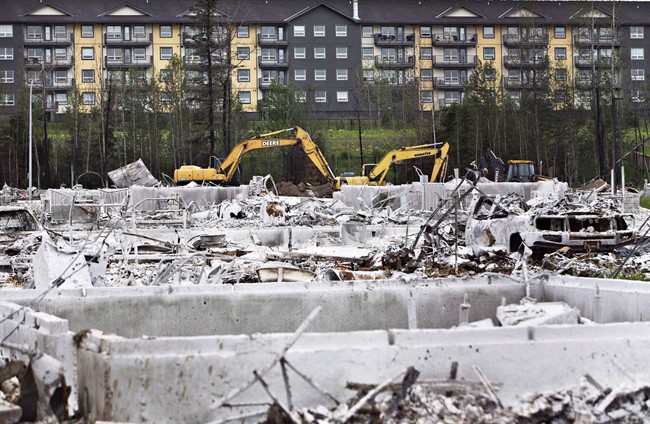 Crews work to clean up the wildfire destruction in Fort McMurray Alta., on June 24, 2016. 