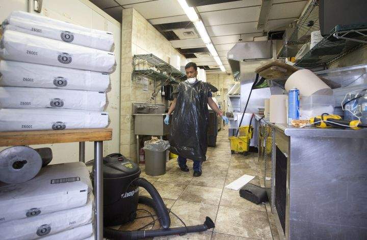 Gover Bumatay cleans up his place of employment in Fort McMurray Alta, on Wednesday June 1, 2016. Residents and business people returned after being evacuated during wildfires,