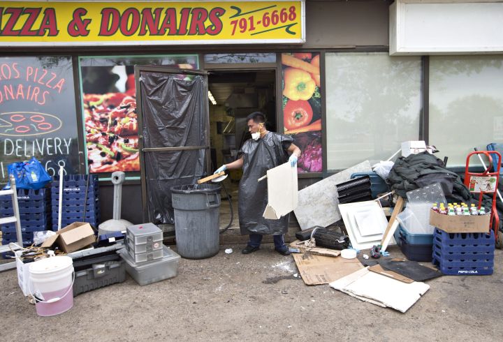 Gover Bumatay cleans up his place of employment in Fort McMurray, Alta., on Wednesday June 1, 2016. Residents and business people returned after being evacuated during wildfires,