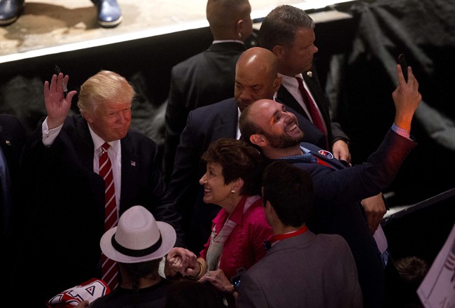 A man takes a selfie as Republican presidential candidate Donald Trump greets supporters after speaking at a rally at the Fox Theater, Wednesday, June 15, 2016, in Atlanta. 