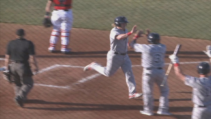 Winnipeg Goldeyes' outfielder Josh Romanski gets high fives after scoring a run on Tuesday in Sioux City.
