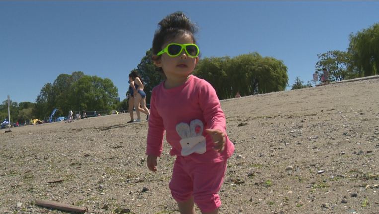 A small child enjoys the rays at Kits Beach on June 4, 2016, during Vancouver's warmest weekend of the year to date. 