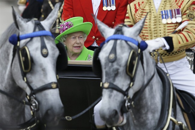 Britain\’s Queen Elizabeth II rides in a carriage during the Trooping The Colour parade at Buckingham Palace, in London, Saturday, June 11, 2016.