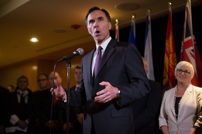 Federal Finance Minister Bill Morneau is flanked by his provincial and territorial counterparts as he speaks during a news conference after reaching a deal to expand the Canada Pension Plan, in Vancouver, B.C., on Monday June 20, 2016. 