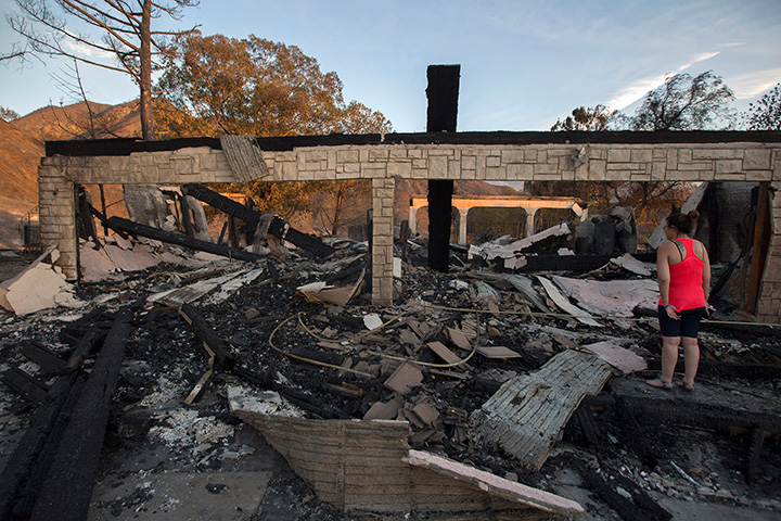 Residents and family members return to a home that was destroyed in the Sand Fire on July 25, 2016 in Santa Clarita, California.