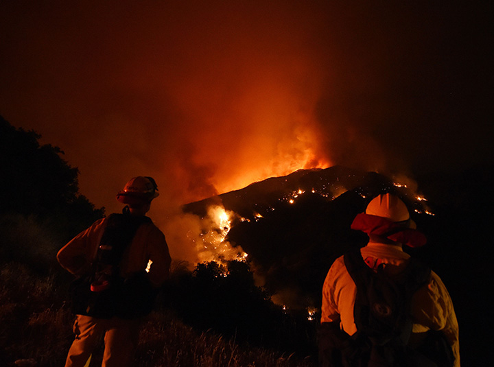 Firefighters watch over the Sand Fire as it moves towards Fair Oaks Canyon in Santa Clarita, California on July 24, 2016.