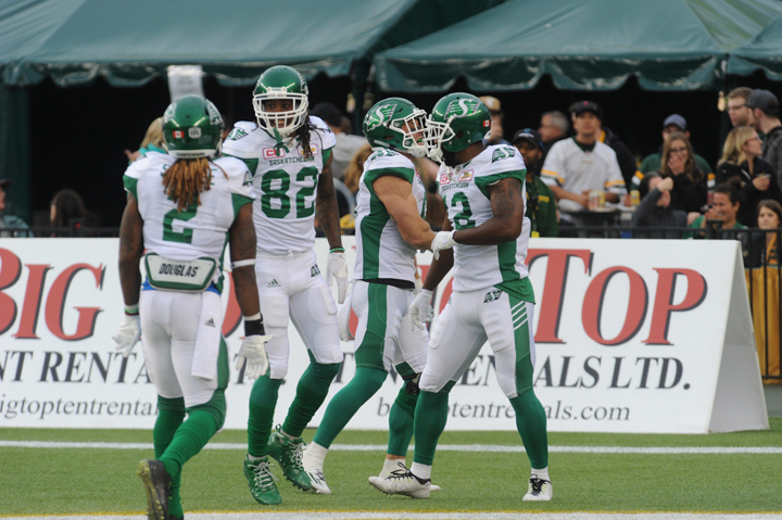 Saskatchewan Roughriders players Curtis Steele (#2), Naaman Roosevelt (#82) and John Chiles (#12) celebrate in the endzone during the 1st quarter of CFL game action between the Edmonton Eskimos and the Saskatchewan Roughriders on Friday, July 08, 2016.