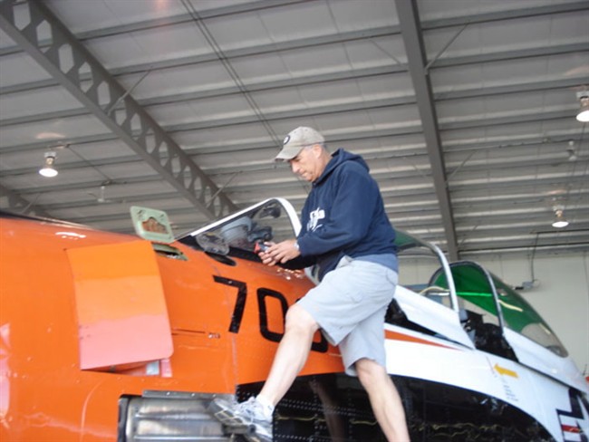 Bruce Evens checks the oil in the engine of his T-28 Trojan in this undated handout photo.