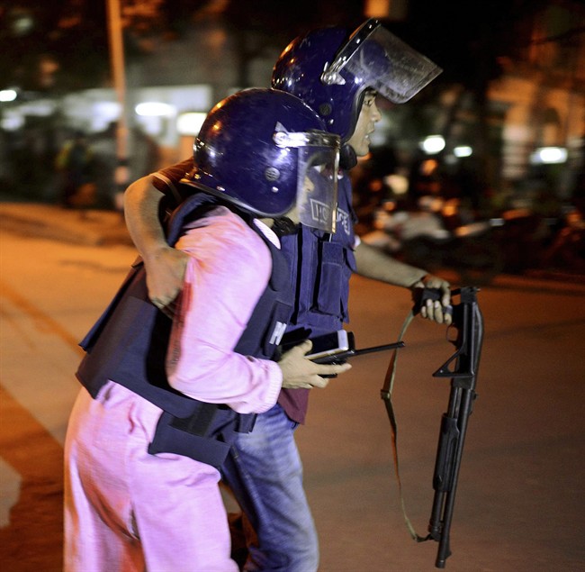 An unidentified security personnel is taken for medical attention after a group of gunmen attacked a restaurant popular with foreigners in a diplomatic zone of the Bangladeshi capital Dhaka, Bangladesh, Friday, July 1, 2016. A group of gunmen attacked a restaurant popular with foreigners in a diplomatic zone of the Bangladeshi capital on Friday night, taking hostages and exchanging gunfire with security forces, according to a restaurant staff member and local media reports.