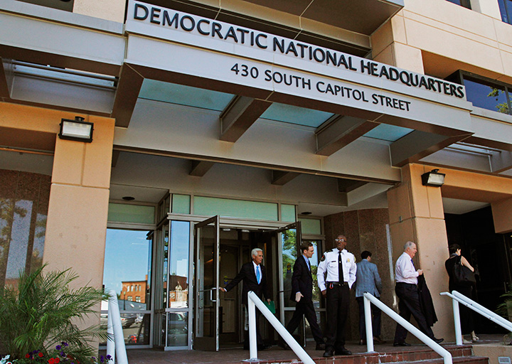 People stand outside the Democratic National Committee headquarters in Washington, Tuesday, June 14, 2016. 