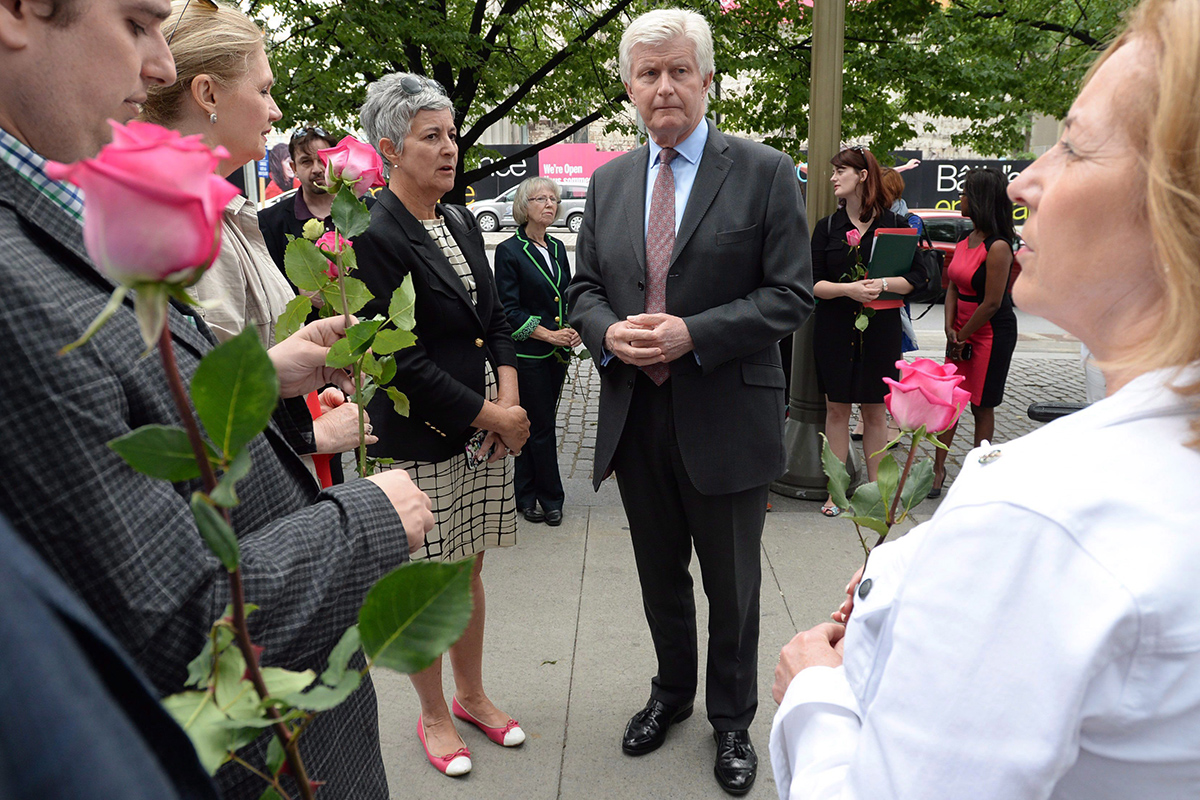 British High Commissioner to Canada Howard Drake, middle right, joins others as they take part in an event titled 'More In Common: A Worldwide Celebration of Jo Cox' at the British High Commission in Ottawa on Wednesday, June 22, 2016. 