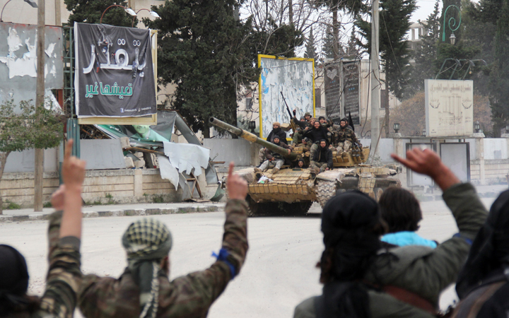 Fighters from a coalition of Islamist forces greet their comrades on March 28, 2015 in the Syrian city of Idlib, the second provincial capital to fall from government control. The capture is a blow to the Syrian regime and raises the prospect that the city will become the effective capital of territory held by Al-Qaeda's Syrian wing, Al-Nusra Front, analysts said.