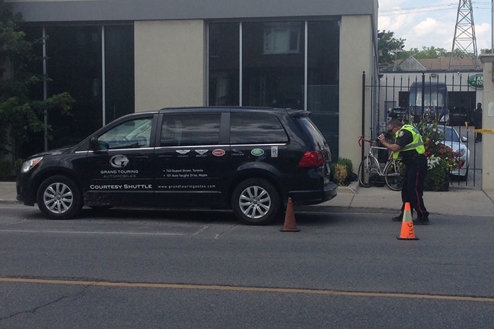 Police investigate after they say a cyclist was fatally injured when he slammed into a parked car while swerving to avoid a turning van.