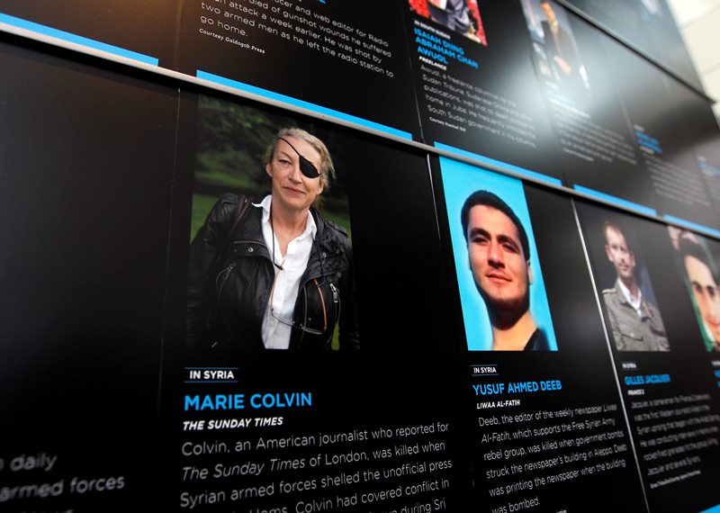 In this May 13, 2013, file photo, the photo of Journalist Marie Colvin who was killed in Syria while she was reporting from there, is seen on the wall of the Newseum during the Journalist Memorial Re-dedication ceremony of the journalists who died reporting the news in 2012 in Washington. 