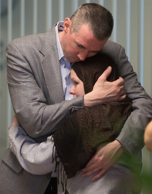 John Nuttall, back, and Amanda Korody embrace at B.C. Supreme Court after a judge ruled the couple were entrapped by the RCMP in a police-manufactured crime, in Vancouver on Friday, July 29, 2016. Justice Catherine Bruce said police instigated and skillfully engineered the very terrorist acts committed by John Nuttall and Amanda Korody, who believed they were planting pressure-cooker bombs that would blow up at the legislature on Canada Day in 2013. 