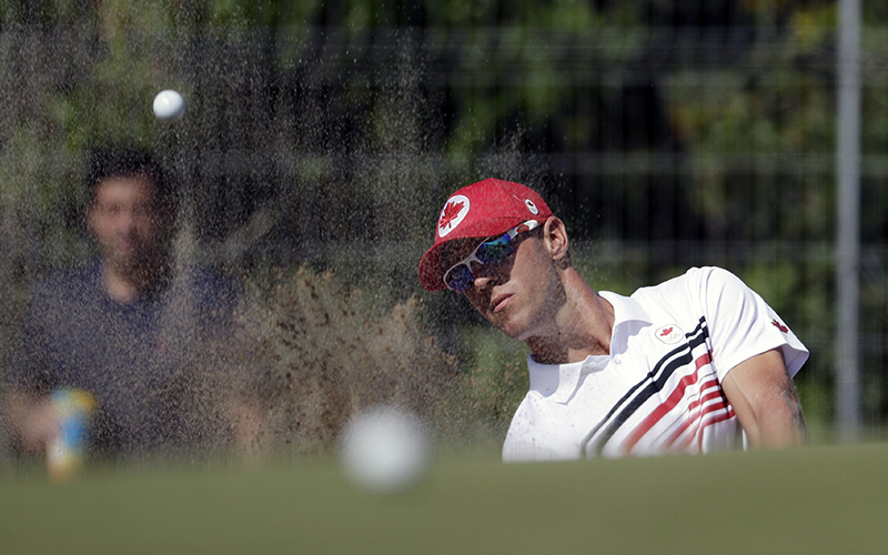 Graham DeLaet of Canada, hits up to the 10th green during the third round of the men’s golf event at the 2016 Summer Olympics in Rio de Janeiro, Brazil, Saturday, Aug. 13, 2016.