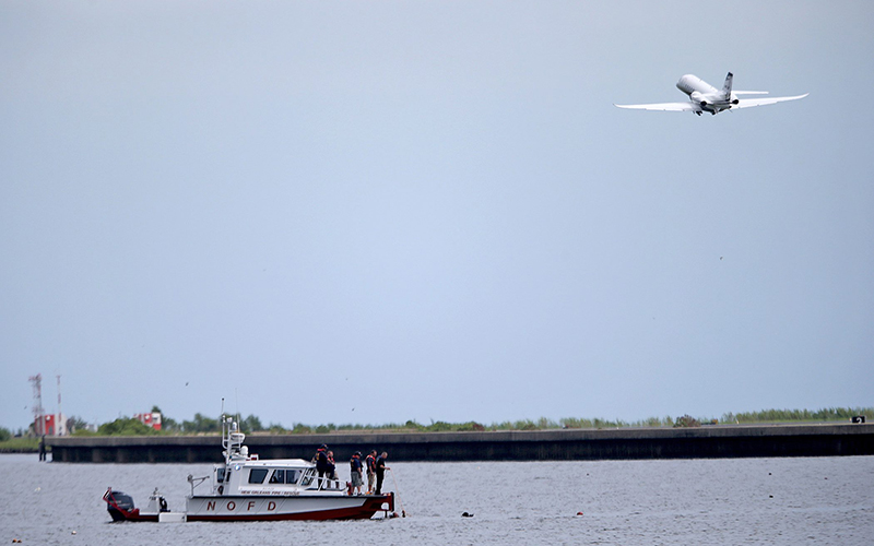 A New Orleans Fire Department boat carrying divers searches for wreckage Sunday, Aug. 28, 2016, near the Seabrook Bridge after a plane crashed into Lake Pontchartrain Saturday night near Lakefront Airport in New Orleans. 