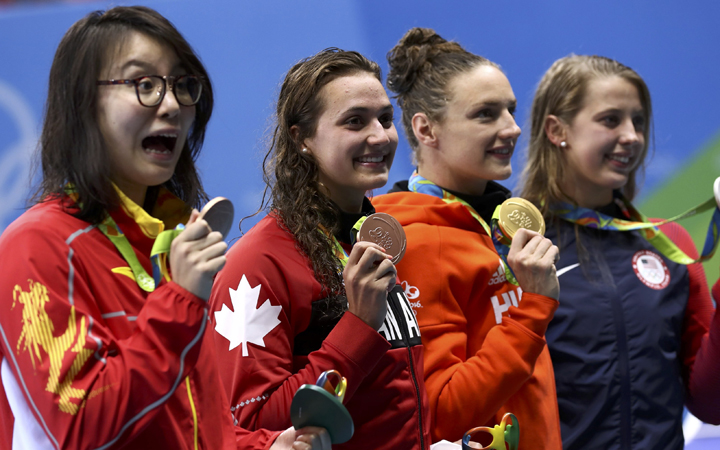 Fu Yuanhui of China, Kylie Masse of Canada, Katinka Hosszu of Hungary and Kathleen Baker of USA pose with their medals after the women's 100m backstroke final.