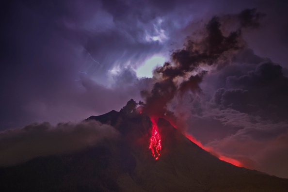 A general view of spewing pyroclastic lava is seen during Mount Sinabung volcano eruption, seen from Tiga Pancur village in Karo, North Sumatra, Indonesia on July 28, 2016. (Photo by Tibta Pangin/Anadolu Agency/Getty Images).