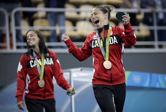 Canada's bronze medalists Roseline Filion, right, and Meaghan Benfeito celebrate after the women's synchronized 10m platform diving final in the Maria Lenk Aquatic Center at the 2016 Summer Olympics in Rio de Janeiro, Brazil, Tuesday, Aug. 9, 2016.