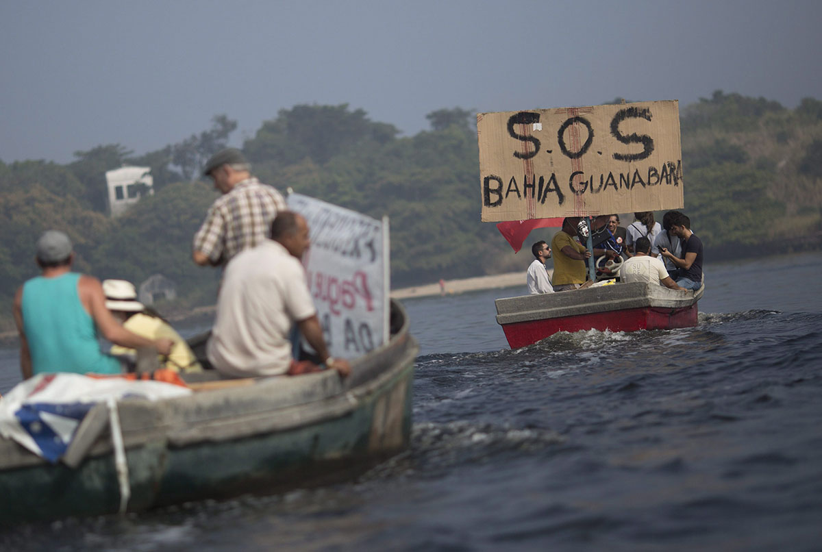 In this Sunday, July 3, 2016 photo, fishermen protest the pollution in the Guanabara bay, in Rio de Janeiro, Brazil. Rio state officials have acknowledged a real cleanup of Guanabara will take 20 years after organizers promised to do it for the Olympics, with the city still pouring at least half of its untreated sewage into its surrounding waters, including Guanabara.