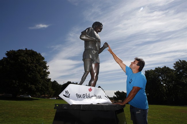 Conrad Burns, a Prince Albert resident, stands near the Terry Fox statue at Mile 0 in Victoria, B.C., Monday, August 8, 2016 after walking across the country. He started at Mile 0 in St. Johns, Nfld, April 1, 2016 to create awareness about abuse and violence.