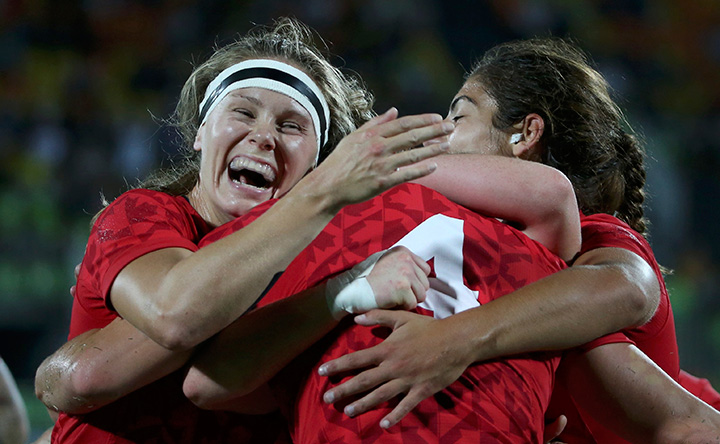 Canada’s Kelly Russell celebrates with teammates after scoring a try against the U.K. during the women’s seven rugby bronze medal match on August 8, 2016 in Rio de Janeiro, Brazil.