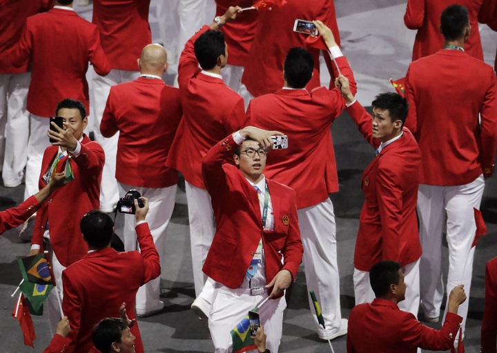 Members of team China take pictures during the opening ceremony for the 2016 Summer Olympics in Rio de Janeiro, Brazil, Friday, Aug. 5, 2016.