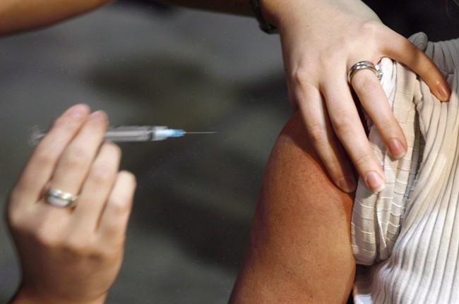 A person gets a shot during a flu vaccine program in Calgary on Oct. 26, 2009. A study has found that people who live in provinces that allow pharmacists to give flu shots are more likely to get vaccinated against the seasonal bug than those living in jurisdictions without such a policy.