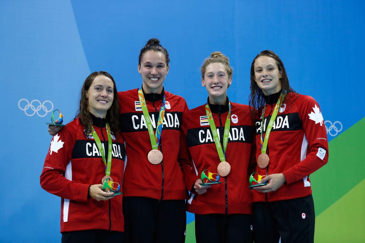 Bronze medalist Sandrine Mainville, Chantal Van Landeghem, Taylor Ruck and Penny Oleksak of Canada pose during the medal ceremony for Final of the Women’s 4 x 100m Freestyle Relay on Day 1 of the Rio 2016 Olympic Games at the Olympic Aquatics Stadium on August 6, 2016 in Rio de Janeiro, Brazil.