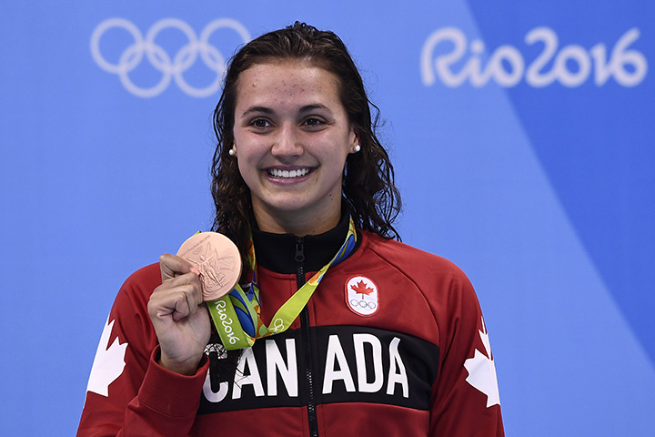 Canada’s Kylie Masse poses with her bronze medal on the podium of the Women’s 100m Backstroke during the swimming event at the Rio 2016 Olympic Games at the Olympic Aquatics Stadium in Rio de Janeiro on August 8, 2016.