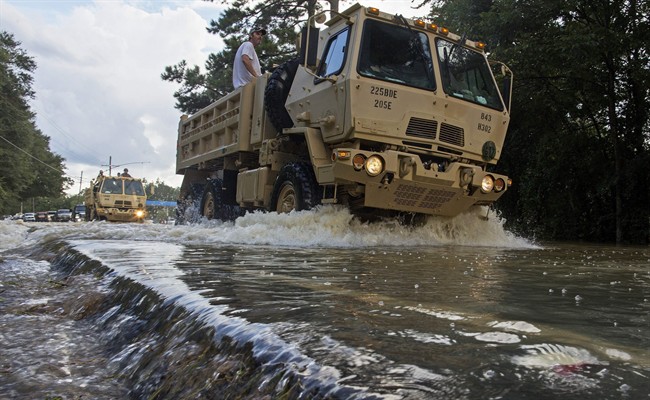 The Louisiana National Guard transports people out of flood hit areas around Walker , La., Monday, Aug. 15, 2016.