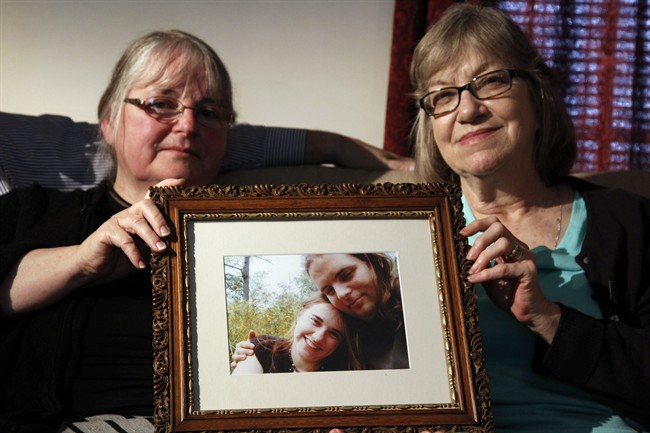 In this June 4, 2014, file photo, mother’s Linda Boyle, left and Lyn Coleman hold photo of their married children, Joshua Boyle and Caitlan Coleman, who were kidnapped by the Taliban in late 2012 in Stewartstown, Pa.
