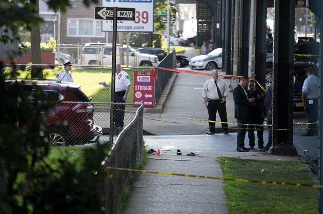 Sandals lay on a street corner at the crime scene, Saturday, Aug. 13, 2016, not far from the Al-Furqan Jame Masjid Mosque in the Ozone Park neighborhood of Queens, New York, where the leader of a New York City mosque has been fatally shot and an associate has been wounded in a brazen daylight attack.