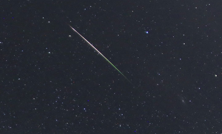 A Perseid streaks across the sky with the Andromeda Galaxy (lower right) in Aven, Switzerland on Aug. 11, 2016.