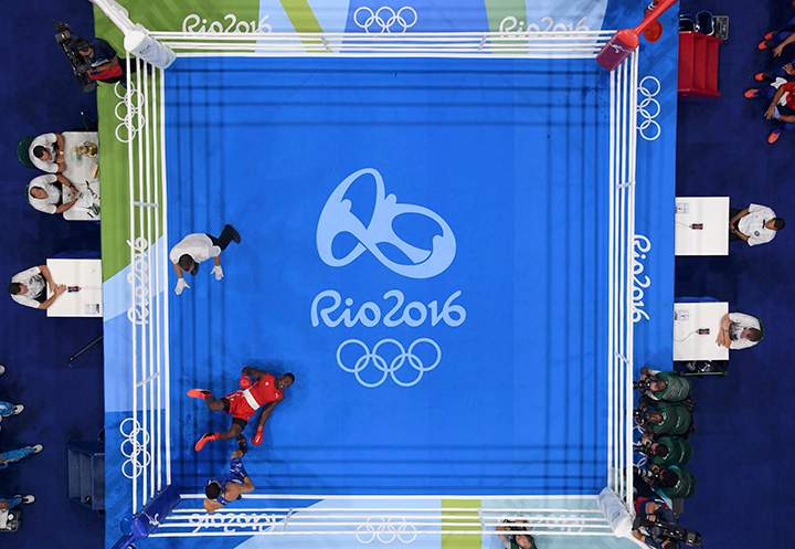 Julio Cesar La Cruz of Cuba falls during his bout with Adilbek Niyazymbetov of Kazakhstan in the men’s 81kg final.
