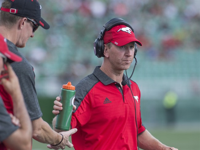 Calgary Stampeders head coach Dave Dickenson looks on as his team takes on the Saskatchewan Roughriders during the first half of CFL football action in Regina on Saturday, August 13, 2016.