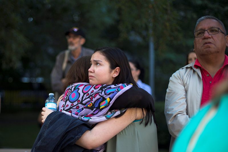 Sarah Fleming hugs her cousin and stands next to her father who are ’60s Scoop survivors at a rally in Toronto on Tuesday, August 23, 2016. Scores of aboriginals from across Ontario rallied in Toronto today ahead of a landmark court hearing on the so-called ’60s Scoop.