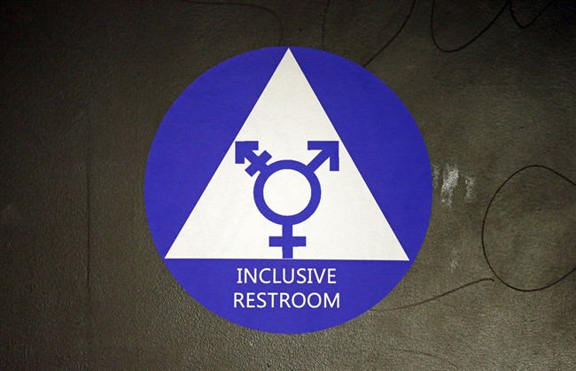 In this May 17, 2016, file photo, a new sticker designates a gender neutral bathroom at Nathan Hale high school in Seattle.