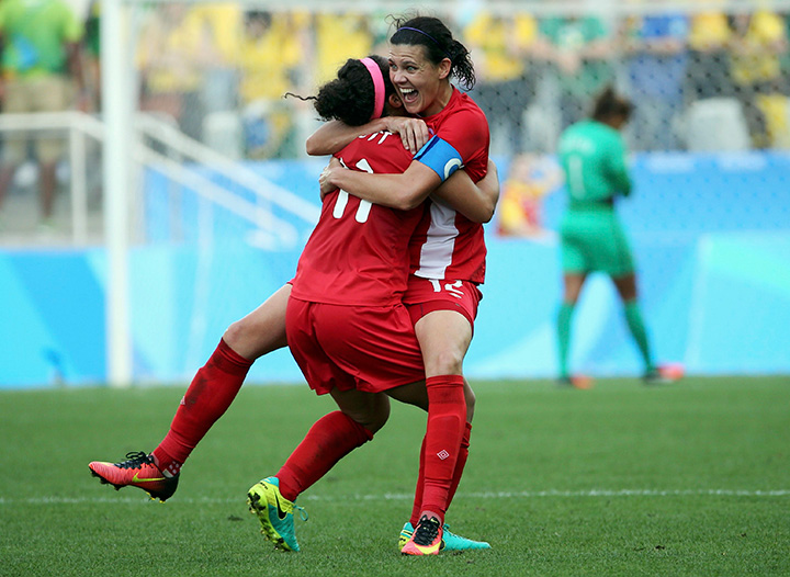 Canada’s Christine Sinclair and Desiree Scott celebrate winning the bronze medal match against Brazil at the Rio Olympics on August 19, 2016.