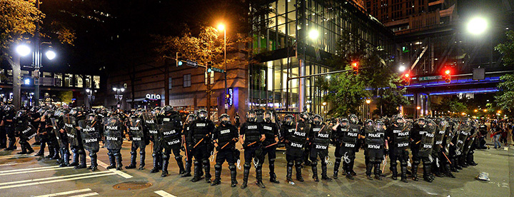 CMPD officers in riot gear block the intersection near the Epicentre in Charlotte, N.C. Wednesday, Sept. 21, 2016.